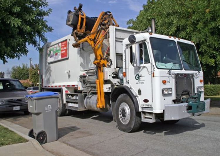 Green Team of San Jose side load garbage truck collecting waste.